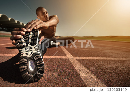 Man, shoes and stretching leg on ground, sunset and fitness for health, sports and performance. Black male person, athlete and warmup on track, workout and commitment or ready, train and outdoors Man, shoes and stretching leg on ground, sunset and fitness for health, sports and performance. Black male person, athlete and warmup on track, workout and commitment or ready, train and outdoors 139303149