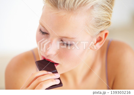 Relax woman, face and eating dark chocolate for antioxidants benefits, morning wellness or stress relief food. Diet cheat meal, eyes closed and person enjoy sugar craving, cacao bar or sweets slab 139303216