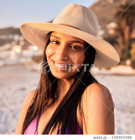 Woman, portrait and beach smile at sunset or holiday vacation, tropical ocean break or happy travel. Indian person, face and tip destination in evening or summer sunshine in peace relax, hat for rest 139303398