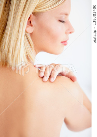 Girl, skincare and touch shoulder in studio with back, eyes closed and beauty by white background. Woman, model and thinking with peace, cosmetic change and transformation with glow for wellness Girl, skincare and touch shoulder in studio with back, eyes closed and beauty by white background. Woman, model and thinking with peace, cosmetic change and transformation with glow for wellness 139303400