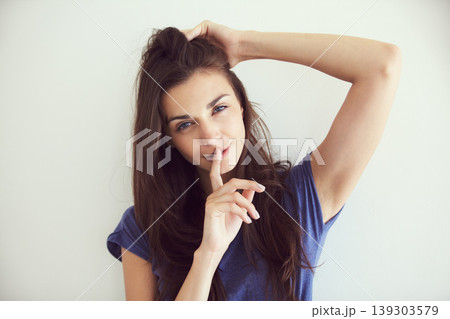Portrait, woman and finger on the lips with a secret, emoji and gossip on white studio background. Face, person and model with privacy, whisper or confidential information with body language or shush Portrait, woman and finger on the lips with a secret, emoji and gossip on white studio background. Face, person and model with privacy, whisper or confidential information with body language or shush 139303579