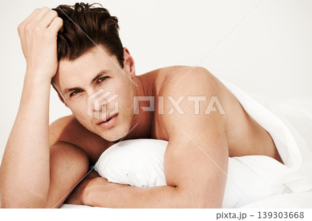 Serious, man and sexy portrait in bed to relax and wake up in morning and home. Shirtless, model and calm face of person in bedroom on vacation, weekend or holiday with blanket, duvet and sheet Serious, man and sexy portrait in bed to relax and wake up in morning and home. Shirtless, model and calm face of person in bedroom on vacation, weekend or holiday with blanket, duvet and sheet 139303668