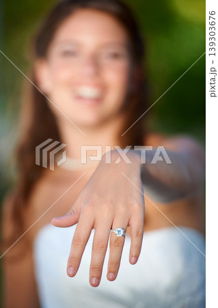 Bride, woman and hand with wedding ring outdoor for marriage, commitment and celebration with diamond. Love, unity and person in nature with jewelry for ceremony, smile and support on park in summer Bride, woman and hand with wedding ring outdoor for marriage, commitment and celebration with diamond. Love, unity and person in nature with jewelry for ceremony, smile and support on park in summer 139303676