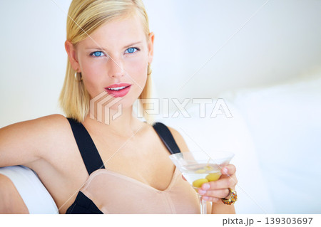 Woman, portrait and drinking alcohol to celebrate, freedom and carefree on vacation, holiday and trip. Female person, relaxing and face for martini, couch and travel to Paris for fun, joy and toast 139303697
