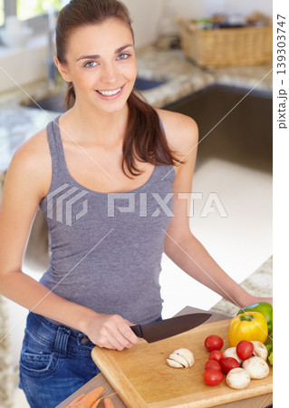 Woman, portrait and happy with knife or vegetables for nutrition, cooking or healthy meal in kitchen of home. Person, face and chopping board with mushroom, peppers and tomato for wellness and diet Woman, portrait and happy with knife or vegetables for nutrition, cooking or healthy meal in kitchen of home. Person, face and chopping board with mushroom, peppers and tomato for wellness and diet 139303747