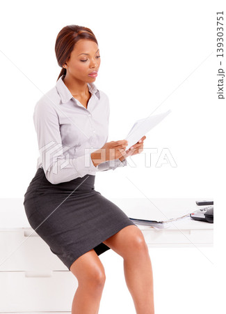 Business woman, studio and reading documents for financial report, planning and review of office taxes. African worker or employee on desk with paperwork for job or accounting on a white background Business woman, studio and reading documents for financial report, planning and review of office taxes. African worker or employee on desk with paperwork for job or accounting on a white background 139303751