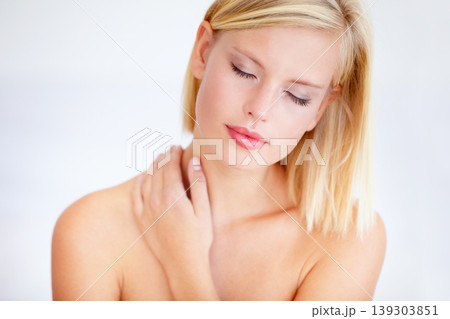 Woman, skincare and wellness with eyes closed in studio for beauty, care or health by white background. Girl, model and peace with touch for skin, cosmetic change and transformation with natural glow 139303851