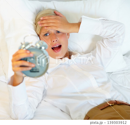 Alarm, sleeping and woman with surprise in bed awake, oversleep and late for working at home. Stress, anxiety and business person shocked for snooze, time and clock for career, job or work in morning 139303912