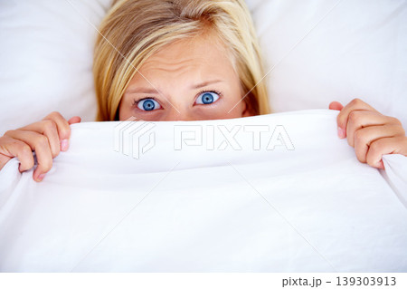 Portrait, bedroom and blanket with woman, fear and scared with anxiety, expression and emotion. Face, person and girl with a sheet, home and depression with stress, mental health and insomnia Portrait, bedroom and blanket with woman, fear and scared with anxiety, expression and emotion. Face, person and girl with a sheet, home and depression with stress, mental health and insomnia 139303913
