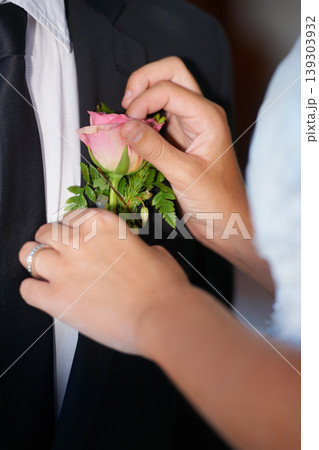 Closeup, hands or flower on wedding suit, tuxedo or jacket in marriage unity, love or event. People, bride or groom couple and rose, plant or boutonniere in celebration, commitment and placement help Closeup, hands or flower on wedding suit, tuxedo or jacket in marriage unity, love or event. People, bride or groom couple and rose, plant or boutonniere in celebration, commitment and placement help 139303932