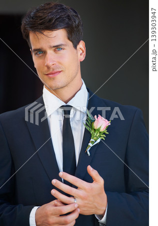 Groom man, portrait and wedding in suit, rose or flower for celebration, event or party with ring. Person, hands and face with choice, marriage and commitment to relationship with floral decoration 139303947