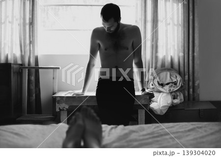 Man, bedroom and depressed with thinking and cheating with black and white and beard at home. Art, fashion and male person in a house with a problem and anxiety with lonely grief and monochrome Man, bedroom and depressed with thinking and cheating with black and white and beard at home. Art, fashion and male person in a house with a problem and anxiety with lonely grief and monochrome 139304020