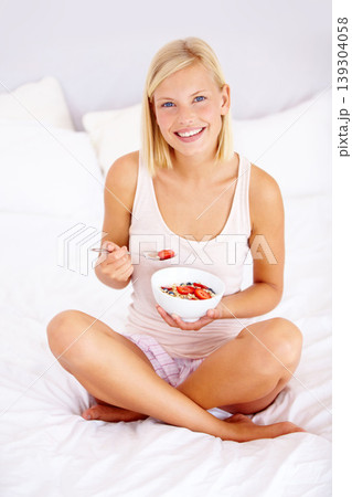 Portrait, home and woman with breakfast, bowl and bedroom with cereal, natural nutrition and wellness. Person, apartment and girl with diet, fruit and holding organic strawberry to lose weight Portrait, home and woman with breakfast, bowl and bedroom with cereal, natural nutrition and wellness. Person, apartment and girl with diet, fruit and holding organic strawberry to lose weight 139304058
