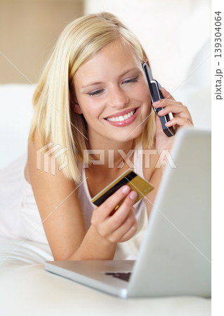 Phone call, sofa and happy woman with laptop, credit card and online shopping with payment in home. Ecommerce, crm and girl on couch with cellphone for deal, offer or internet sale in living room. 139304064