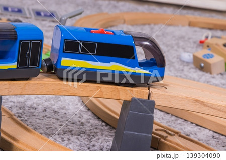 Wooden toy tracks and train for play of children. Child development and happy childhood Wooden toy tracks and train for play of children. Child development and happy childhood 139304090