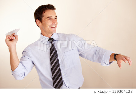Business man, throw paper plane and happy for thinking, vision or game with transport symbol by white background. Entrepreneur, airplane and smile with ideas, icon and playful at accounting agency 139304128