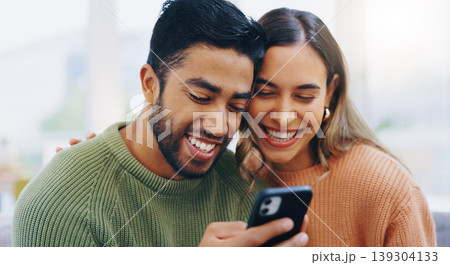 Couple, living room couch and happy with phone, smile and click for contact, meme and notification in home. Man, woman and texting with smartphone, reading and app for social network, video and relax 139304133