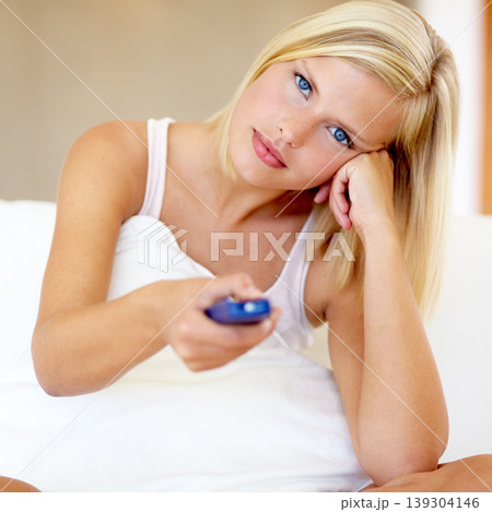 Relax, portrait and woman on sofa watching tv with remote, pillow and streaming movies in home. Controller, television and girl on couch in living room with choice of video, film or network show. Relax, portrait and woman on sofa watching tv with remote, pillow and streaming movies in home. Controller, television and girl on couch in living room with choice of video, film or network show. 139304146