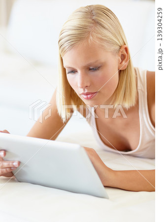 Home, tablet and woman on bed for social media, online shopping and internet in bedroom. Relax, resting and person on digital tech for reading website, news blog and research on weekend in morning Home, tablet and woman on bed for social media, online shopping and internet in bedroom. Relax, resting and person on digital tech for reading website, news blog and research on weekend in morning 139304259