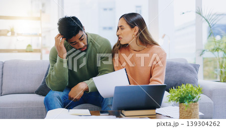 Couple, debt and stress at laptop in home for poor savings, bills and budget of mortgage crisis, taxes or rent. Frustrated man, woman and banking documents for bankruptcy, financial risk or inflation 139304262
