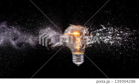 Shattering light real bulb exploding with glass particles Shattering light real bulb exploding with glass particles 139304286