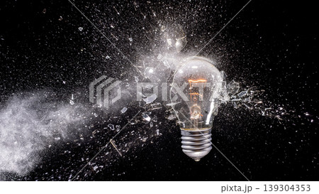 Real Light bulb exploding creating shattered glass impact Real Light bulb exploding creating shattered glass impact 139304353