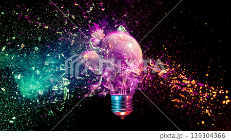 Lightbulb exploding into colorful particles black background Lightbulb exploding into colorful particles black background 139304366