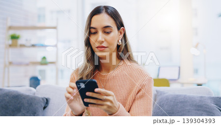 Woman, phone and home on living room sofa with reading, texting or typing for email, contact or web blog. Girl, smartphone and check notification for update, news or social media app on lounge couch 139304393