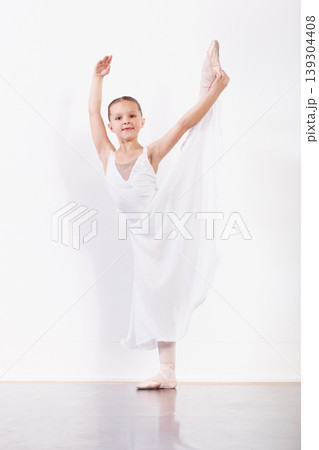 Portrait, stretching and girl in ballet studio with pose, balance and modern dance class. Performance, talent and young ballerina dancer with pride, confidence and creative child at learning academy. Portrait, stretching and girl in ballet studio with pose, balance and modern dance class. Performance, talent and young ballerina dancer with pride, confidence and creative child at learning academy. 139304408