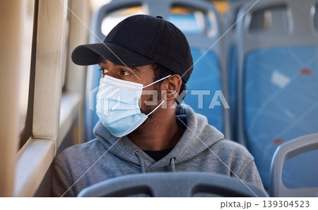 Man, mask or travel in bus in city, cold protection or window view for thinking on journey. Young person, cap or medical cover on mouth for flu virus, transport safety or healthcare rules on vehicle Man, mask or travel in bus in city, cold protection or window view for thinking on journey. Young person, cap or medical cover on mouth for flu virus, transport safety or healthcare rules on vehicle 139304523