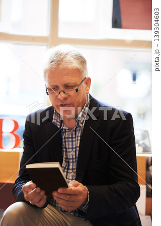 Reading, books and mature man in library for literature, information and knowledge in bookstore. Bookshelf, shopping and senior person with choice, decision and option for story, novel and learning 139304603