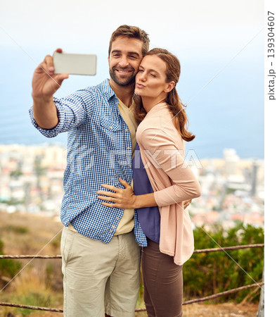 Couple, hug and selfie on vacation, phone and outdoors on adventure, love and memories for social media. Happy people, smartphone and bonding or technology, travel and holiday or pout on date Couple, hug and selfie on vacation, phone and outdoors on adventure, love and memories for social media. Happy people, smartphone and bonding or technology, travel and holiday or pout on date 139304607