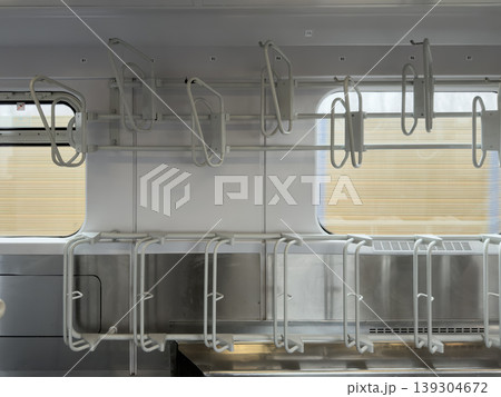 Modern train interior showcases empty bicycle racks above seats, emphasizing sustainable urban commuting and public transport infrastructure Modern train interior showcases empty bicycle racks above seats, emphasizing sustainable urban commuting and public transport infrastructure 139304672