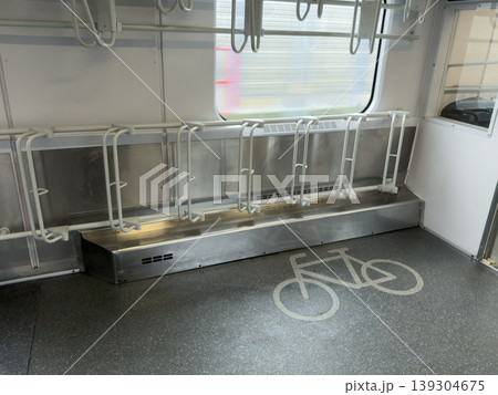 Interior of modern train carriage showing dedicated bicycle racks and floor marking, promoting sustainable commuting and public transport options for cyclists 139304675