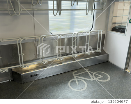 Modern public transport interior featuring dedicated bicycle rack system and clear floor marking indicating cyclist-friendly space, promoting multimodal commuting 139304677
