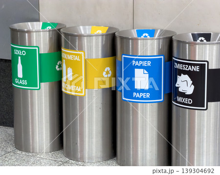 Recycling bins for different waste types are arranged in a row, promoting environmental awareness and sustainable waste management practices Recycling bins for different waste types are arranged in a row, promoting environmental awareness and sustainable waste management practices 139304692