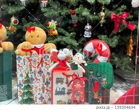 Festive Christmas toys and gifts arranged beneath a decorated tree, creating a charming holiday scene and promotional display for seasonal shopping Festive Christmas toys and gifts arranged beneath a decorated tree, creating a charming holiday scene and promotional display for seasonal shopping 139304694