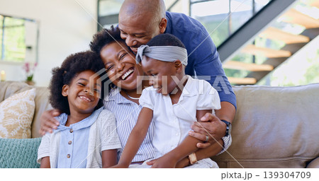 Happy family, children and hug on sofa in living room for bond, embrace and together. Black man, woman and girl with laugh for funny joke, story or memory with love, care and relationship in home Happy family, children and hug on sofa in living room for bond, embrace and together. Black man, woman and girl with laugh for funny joke, story or memory with love, care and relationship in home 139304709
