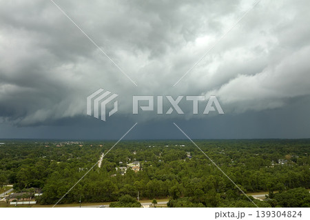 Landscape of dark ominous clouds forming on stormy sky before heavy thunderstorm over rural town area Landscape of dark ominous clouds forming on stormy sky before heavy thunderstorm over rural town area 139304824