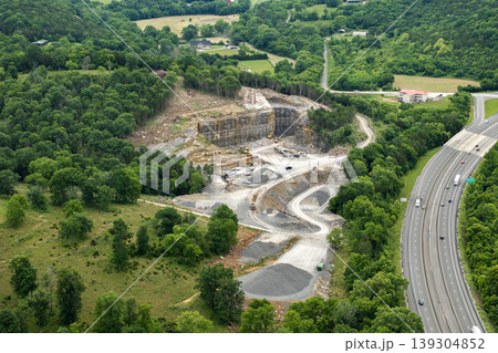 Industrial open-pit mining site with limestone quarry at mountain hillside 139304852