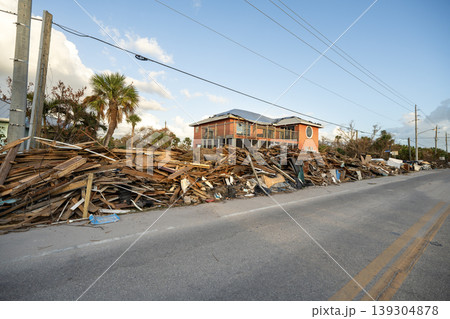 Hurricane damage in Florida. Piles of rubbish on street side from destroyed houses. Consequences of natural disaster 139304878