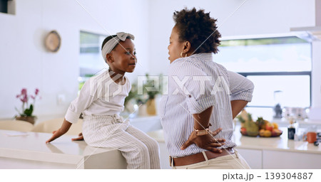 Tired, mom and child in kitchen together, talking and bonding with back pain, breakfast and burnout. Fatigue, mother and daughter on home counter with stress, exhausted and getting ready in morning. Tired, mom and child in kitchen together, talking and bonding with back pain, breakfast and burnout. Fatigue, mother and daughter on home counter with stress, exhausted and getting ready in morning. 139304887
