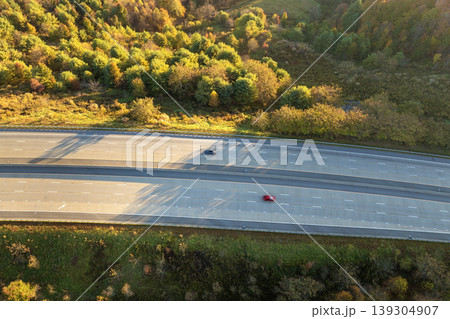 Highway road in American rural area. Expressway lanes for fast passing of car traffic Highway road in American rural area. Expressway lanes for fast passing of car traffic 139304907