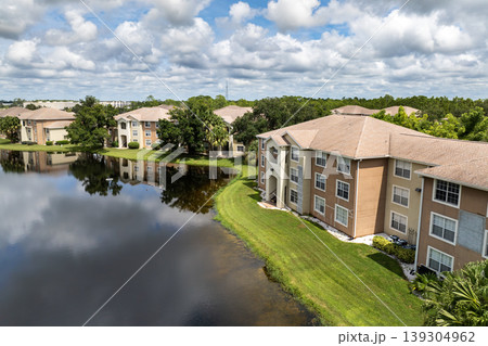Gated community with new apartment condos in Florida suburban area. Family housing in quiet neighborhood. Real estate development in American suburbs Gated community with new apartment condos in Florida suburban area. Family housing in quiet neighborhood. Real estate development in American suburbs 139304962