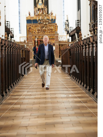 Walking, aisle and senior man in a church for sightseeing on a weekend trip, vacation or holiday. Portrait, religion and holy elderly male person in retirement in a worship cathedral in the city. Walking, aisle and senior man in a church for sightseeing on a weekend trip, vacation or holiday. Portrait, religion and holy elderly male person in retirement in a worship cathedral in the city. 139305037