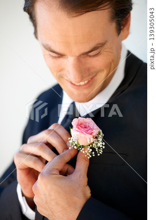 Groom man, boutonniere or flowers with hands for suit for pride, smile or ready at wedding, party or celebration. Person, excited or rose on tuxedo for thinking, prepare or happy for marriage event 139305043