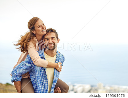 Couple, piggy back and smile for love, outdoors and vacation or holiday, date and bonding in nature. Happy people, play and fun on trip, travel and connection in marriage, support and trust or face 139305076