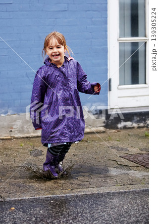 Child, portrait and splash in mud puddle in raincoat for winter fun, explore city or cold weather happy. Young girl, excited and water on holiday vacation break for wet game or joy, surprise as kid Child, portrait and splash in mud puddle in raincoat for winter fun, explore city or cold weather happy. Young girl, excited and water on holiday vacation break for wet game or joy, surprise as kid 139305224