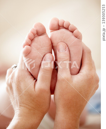 Feet, baby and closeup of hands of mother in a house with love, care and support, nurture and protection. Family, zoom and toes of kid with parent at home for child development, bonding and comfort Feet, baby and closeup of hands of mother in a house with love, care and support, nurture and protection. Family, zoom and toes of kid with parent at home for child development, bonding and comfort 139305253