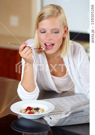 Woman, eating breakfast and reading newspaper to relax, peace and newsletter at home. Female person, breaking news and announcement or information, article and nutrition or fiber, fruit and health Woman, eating breakfast and reading newspaper to relax, peace and newsletter at home. Female person, breaking news and announcement or information, article and nutrition or fiber, fruit and health 139305266